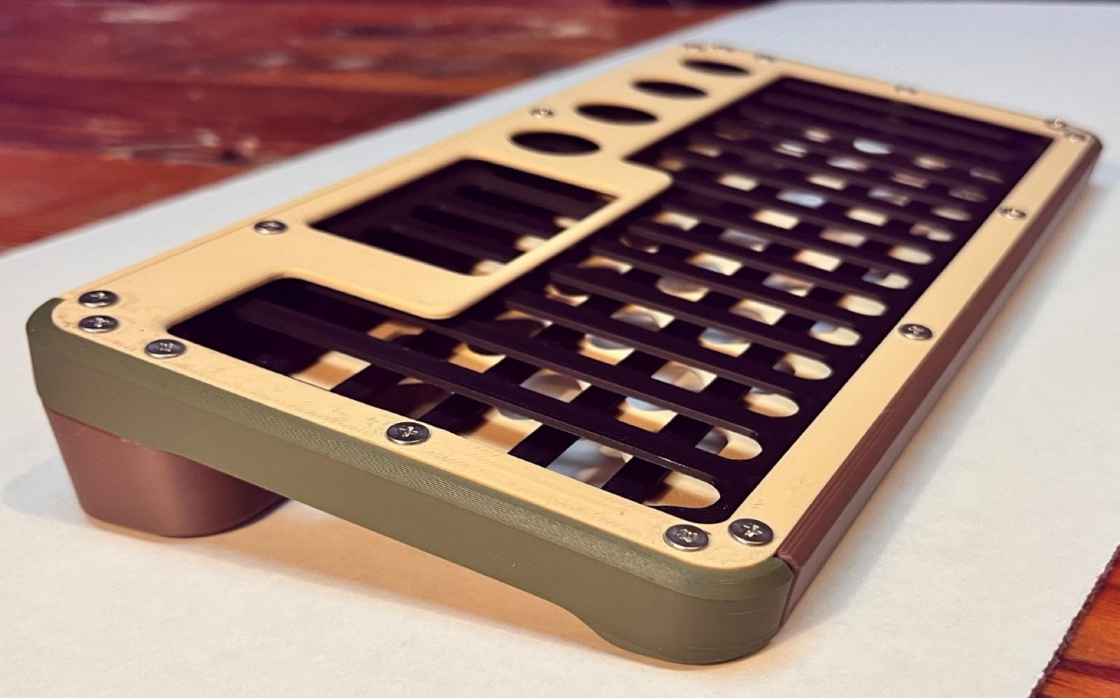 Printed shell on a desk showing the keyboard cutout grid, display window and four knob holes