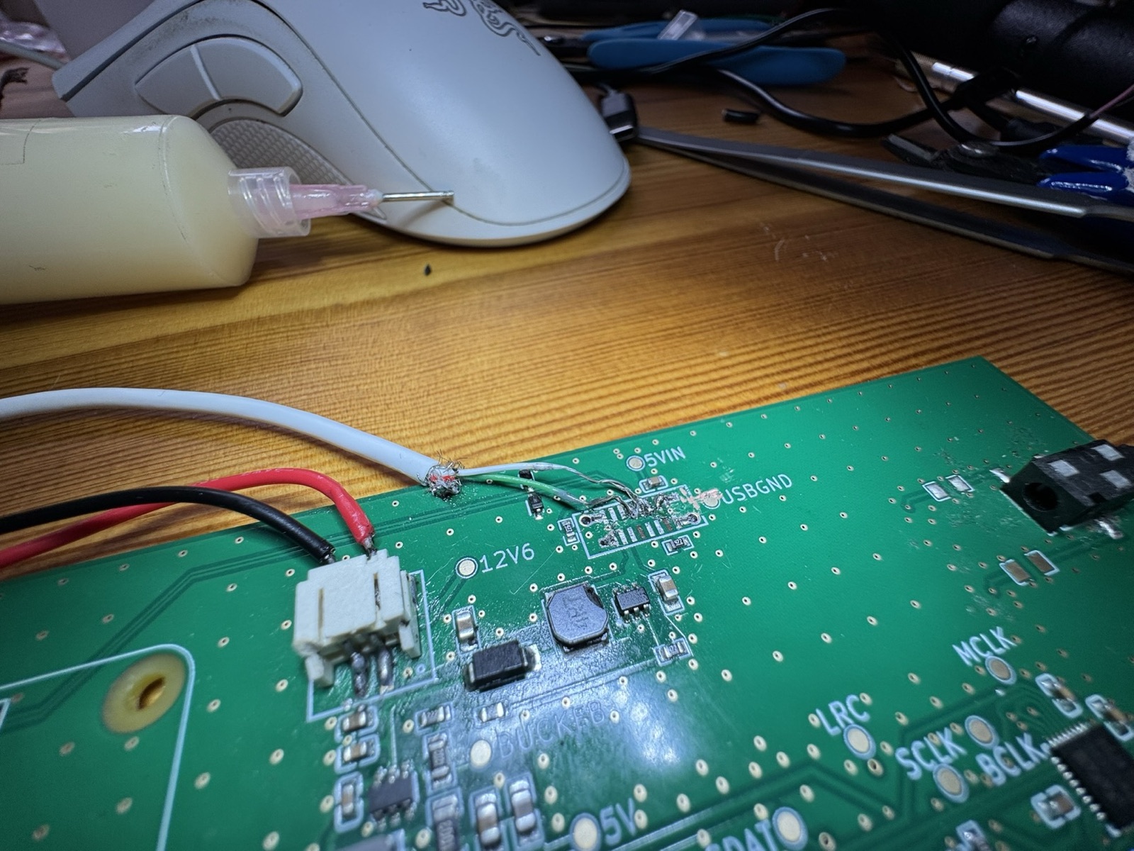 A USB cable cut open with its wires soldered directly onto the board where the USB connector used to be