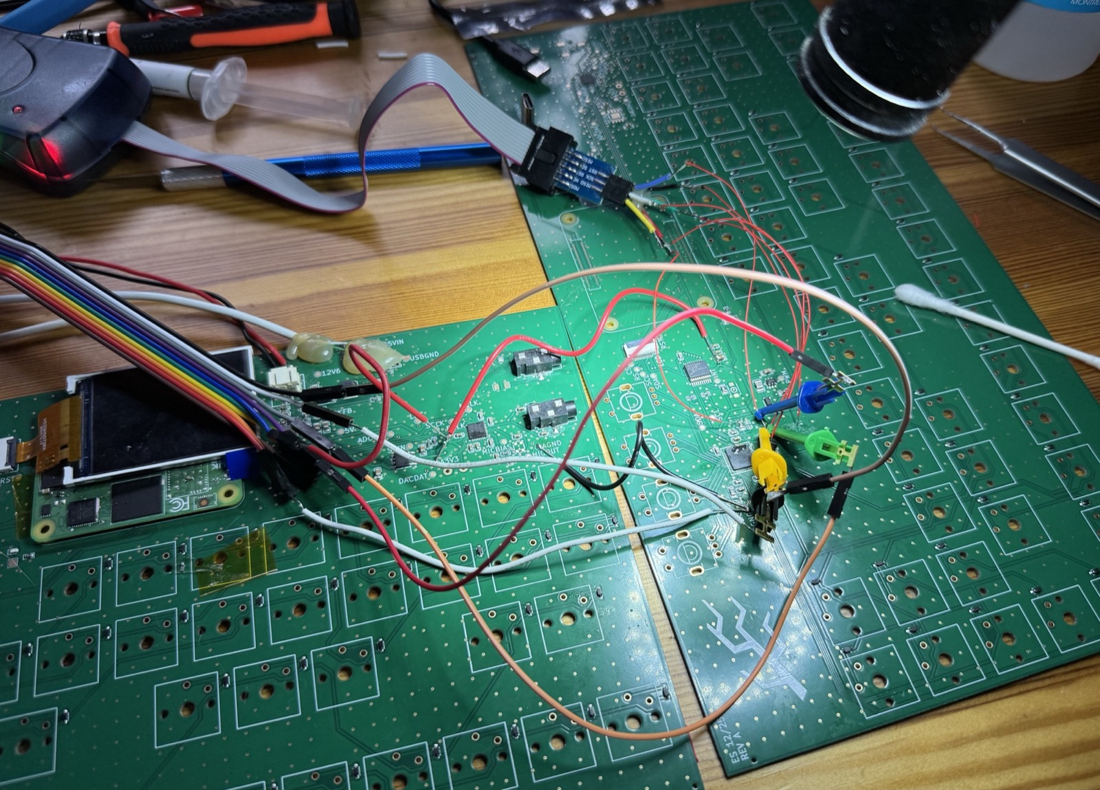 Two circuit boards with a tangle of red wires between them, a logic analyser clipped on and an Arduino at the edge